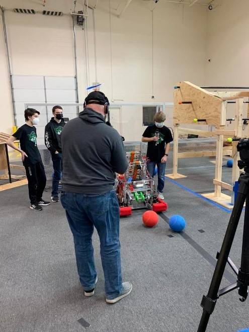 Tyler Olds, from FIRST Updates Now, interviews team members about their robot.  This is excellent practice for the high school students, as they will have to be able to talk about their robots during the regular season.